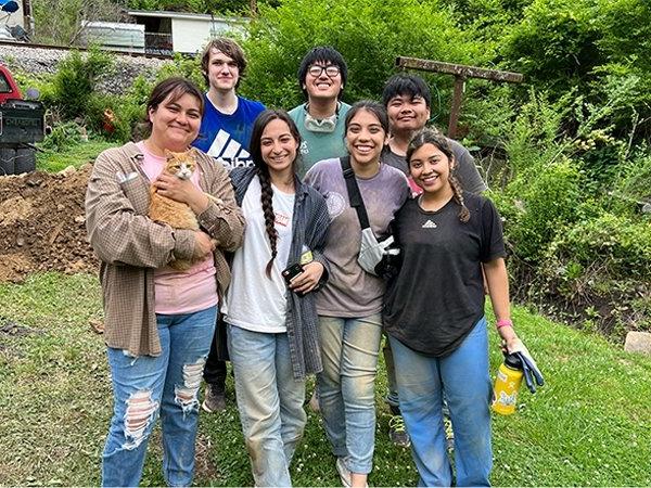 Group photo of students working on service project on site